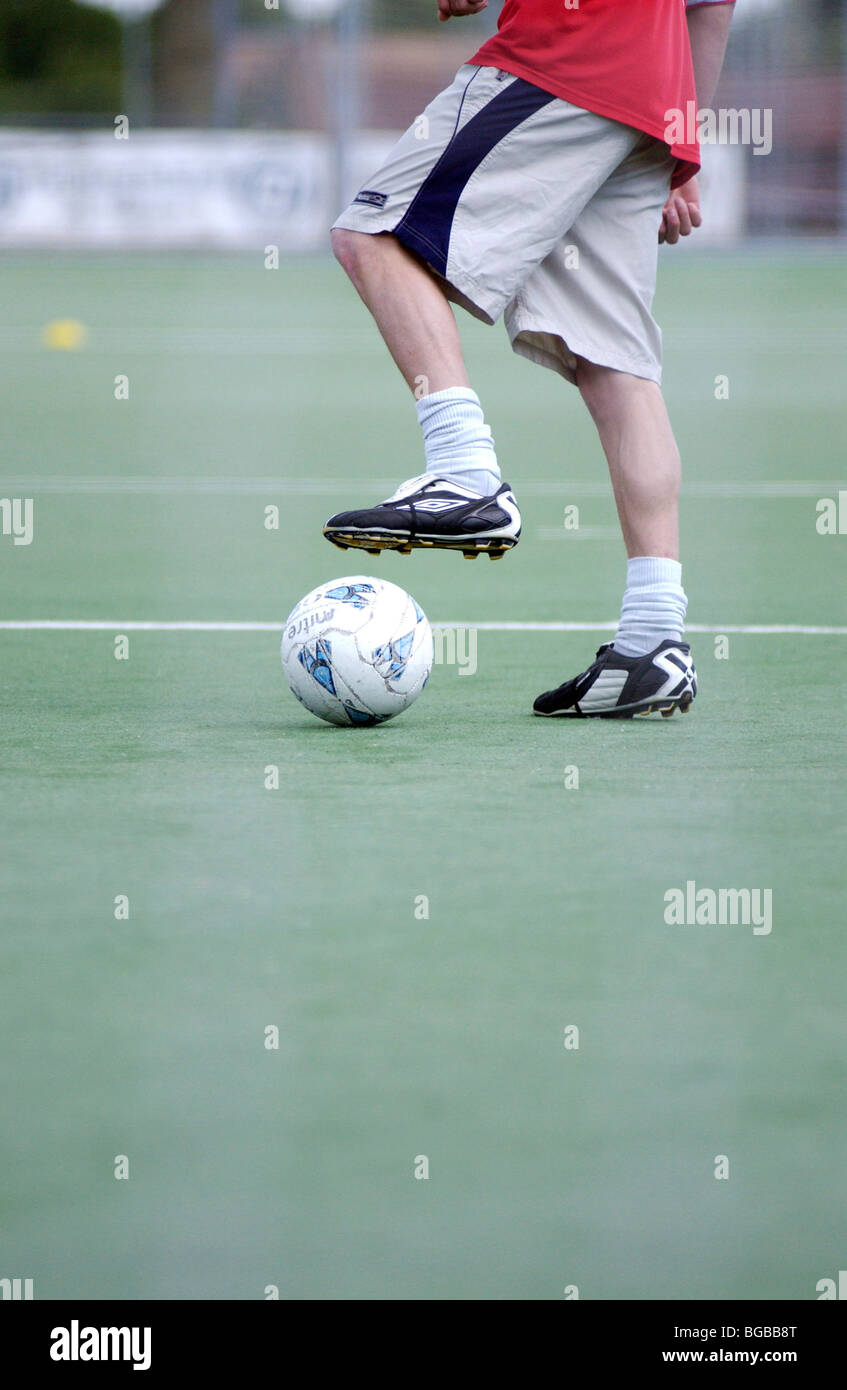 Photograph of football placing dribbling student astro turf ball Stock Photo
