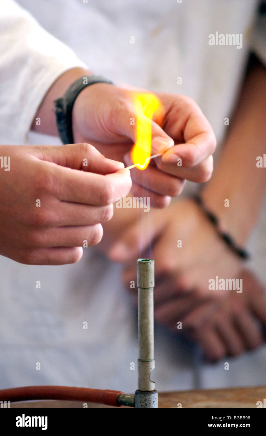 Royalty free photograph of student practical science lesson hands bunsen burner flame UK Stock Photo