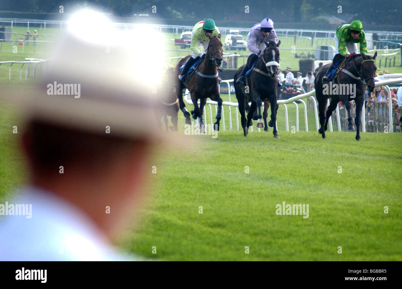 Royalty free photograph of sporting punter/ official looking at the race course on race day in the summer with panama hat UK Stock Photo