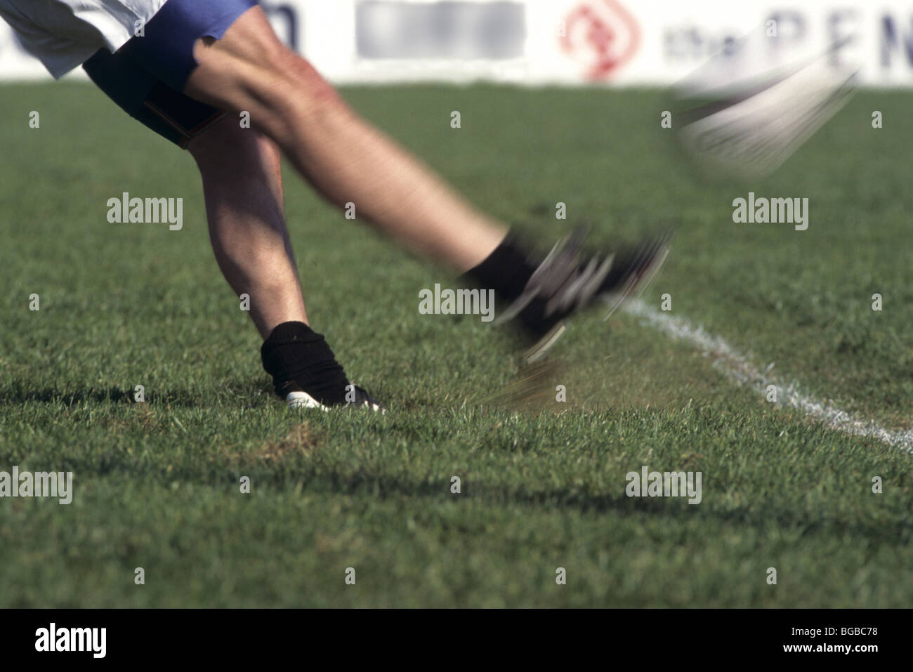 Rugby player kicks the ball off the tee Stock Photo Alamy