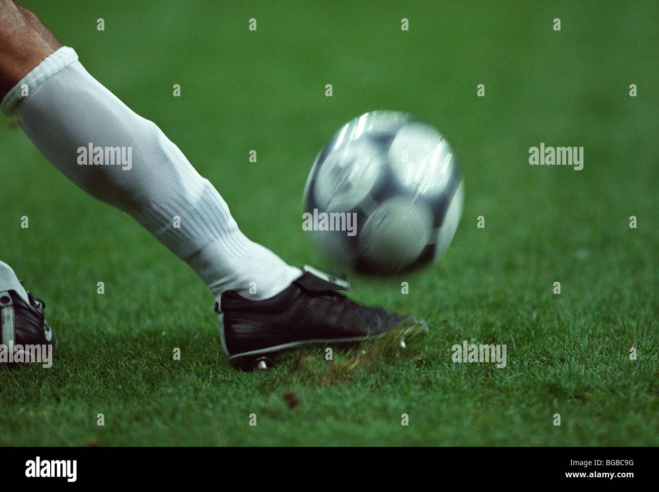 Football player kicking the ball Stock Photo Alamy