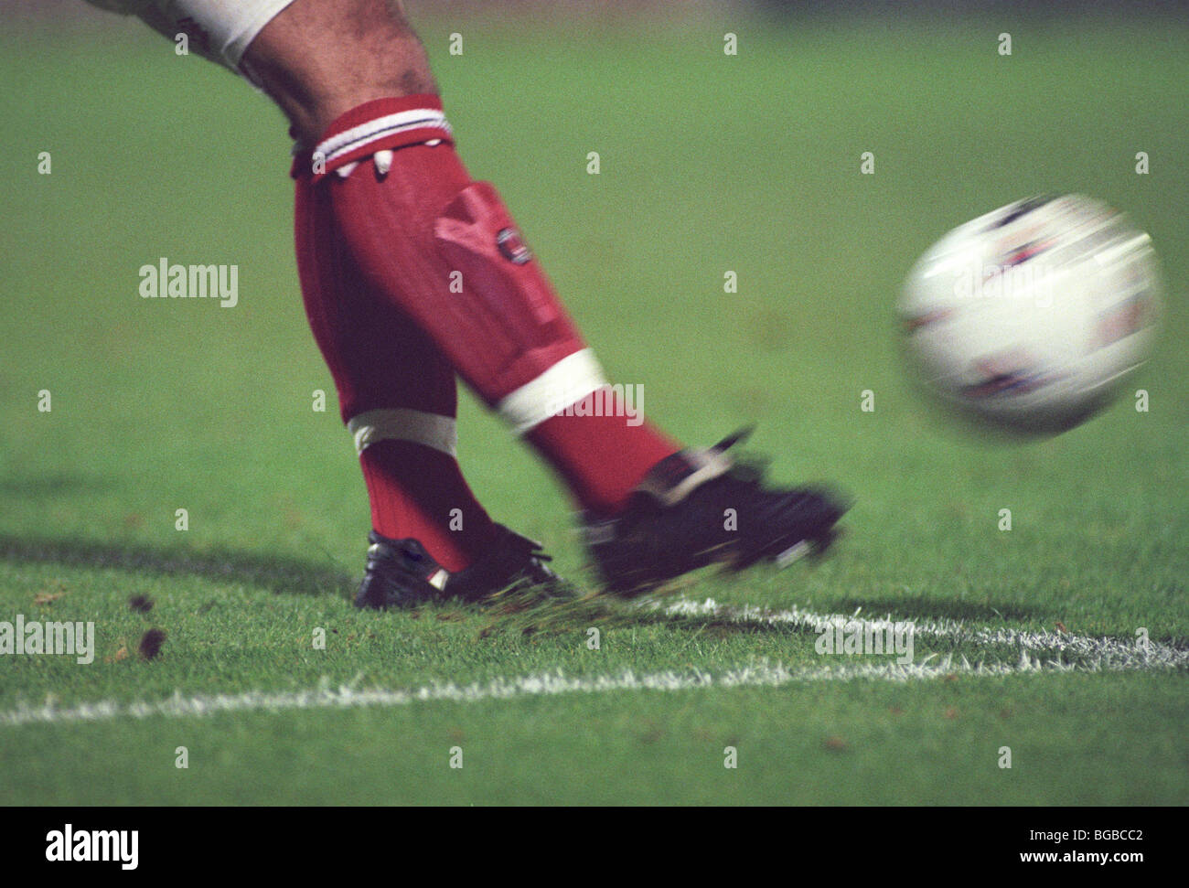 Football player kicking the ball Stock Photo Alamy