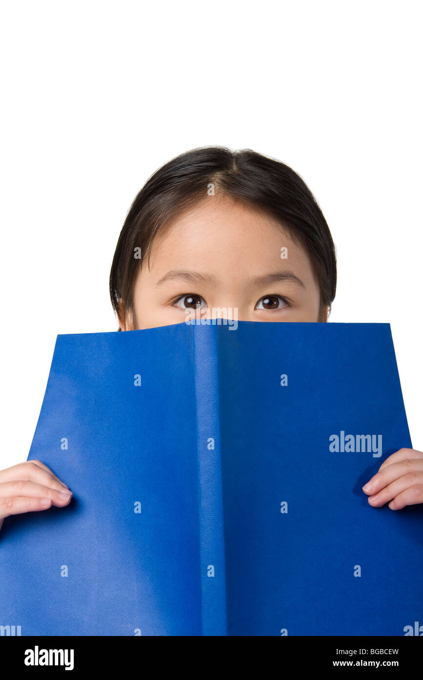 Little girl covers her face with a book Stock Photo Alamy