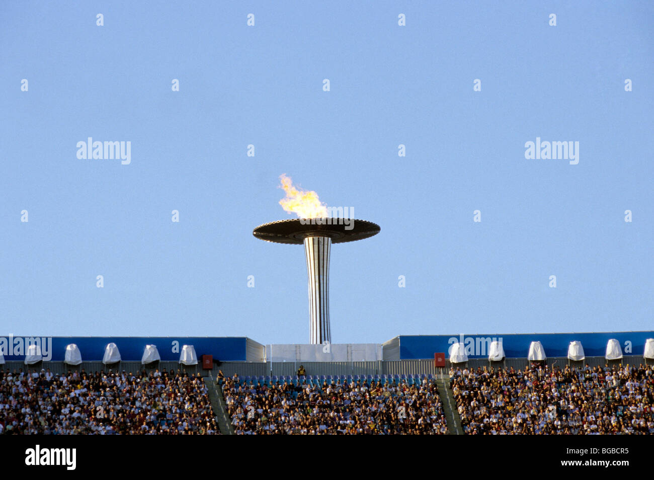 Olympic torch above a stadium Stock Photo Alamy