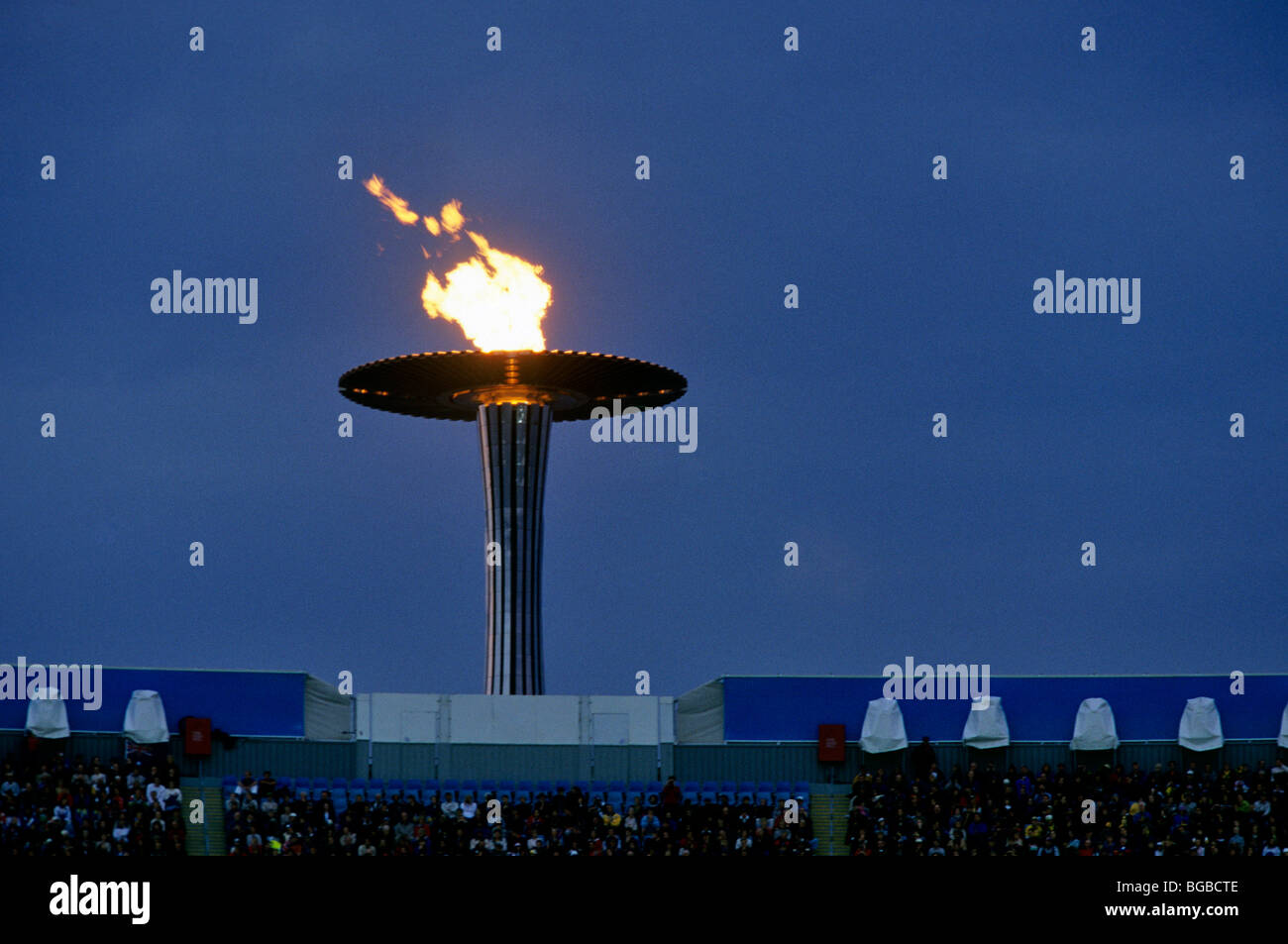 Olympic torch above a stadium Stock Photo Alamy
