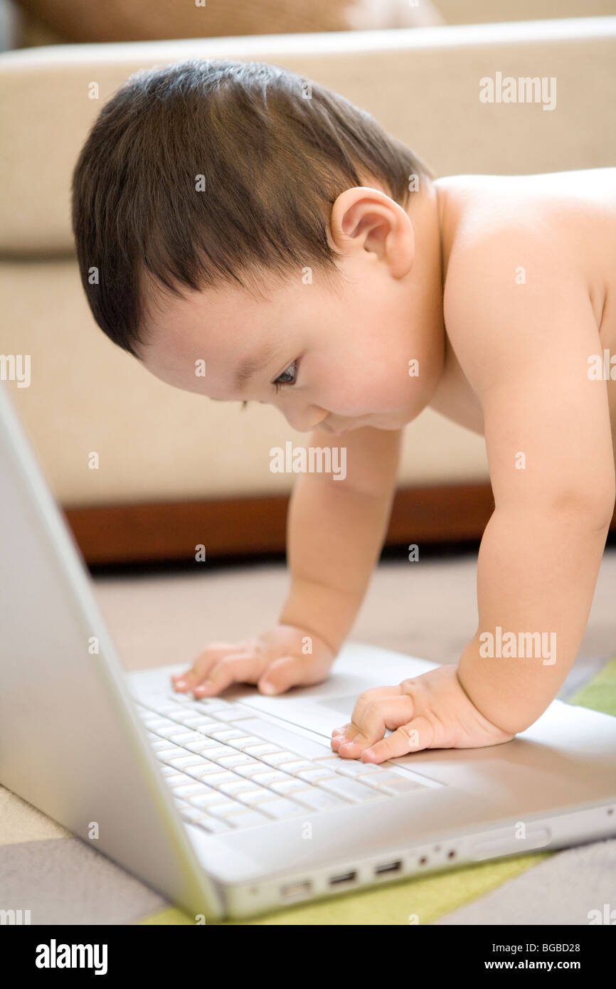 Infant with laptop Stock Photo - Alamy