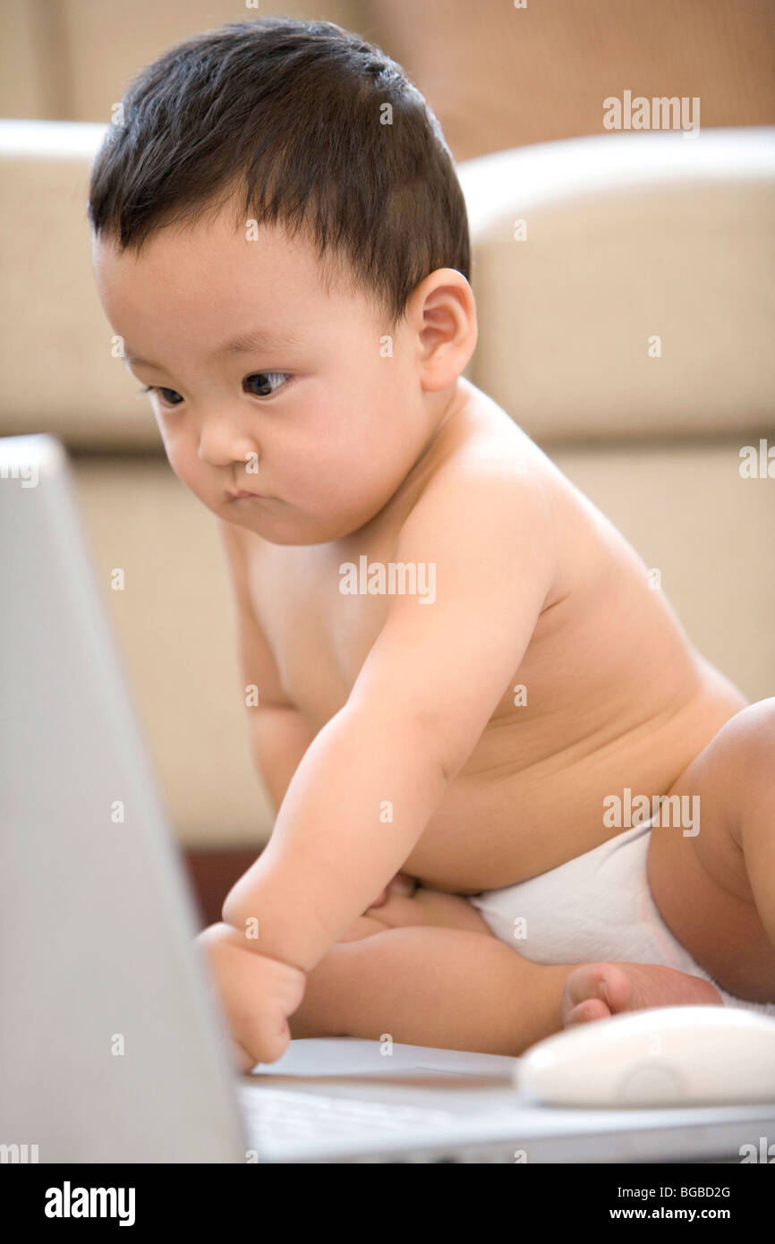 Infant with laptop Stock Photo - Alamy