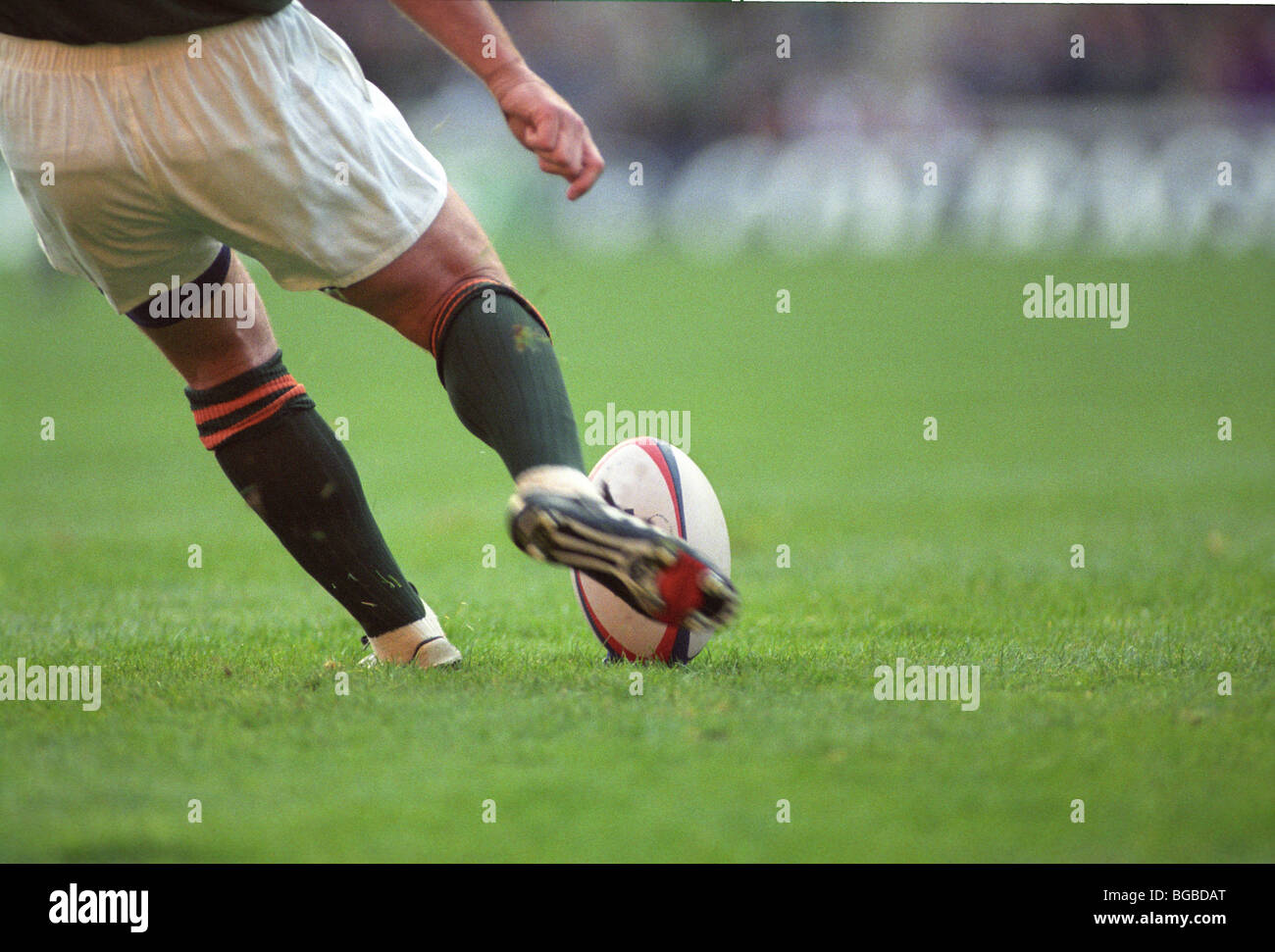 Rugby player kicks the ball off the tee Stock Photo Alamy