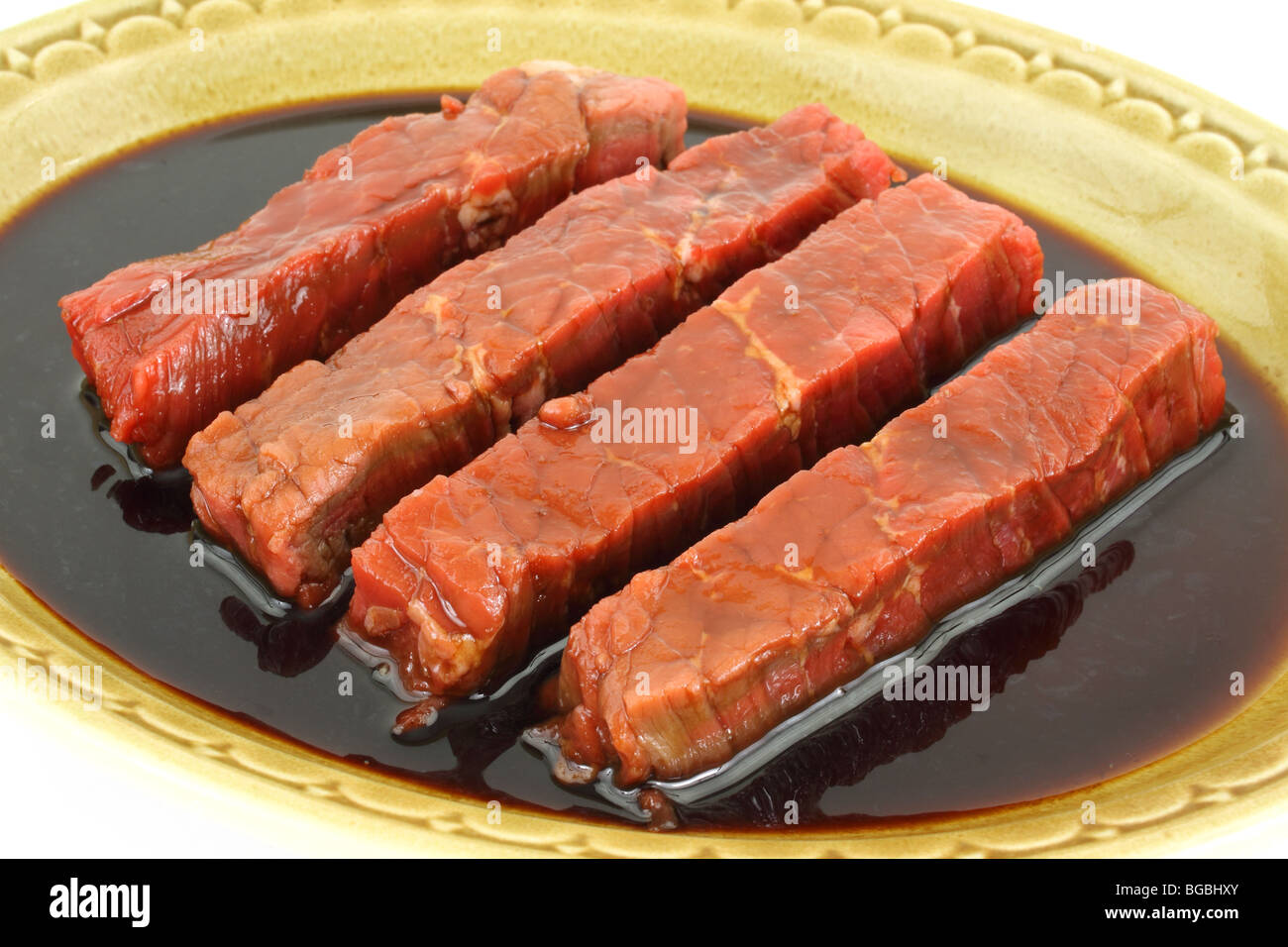 Marinated steak strips in old dish Stock Photo Alamy
