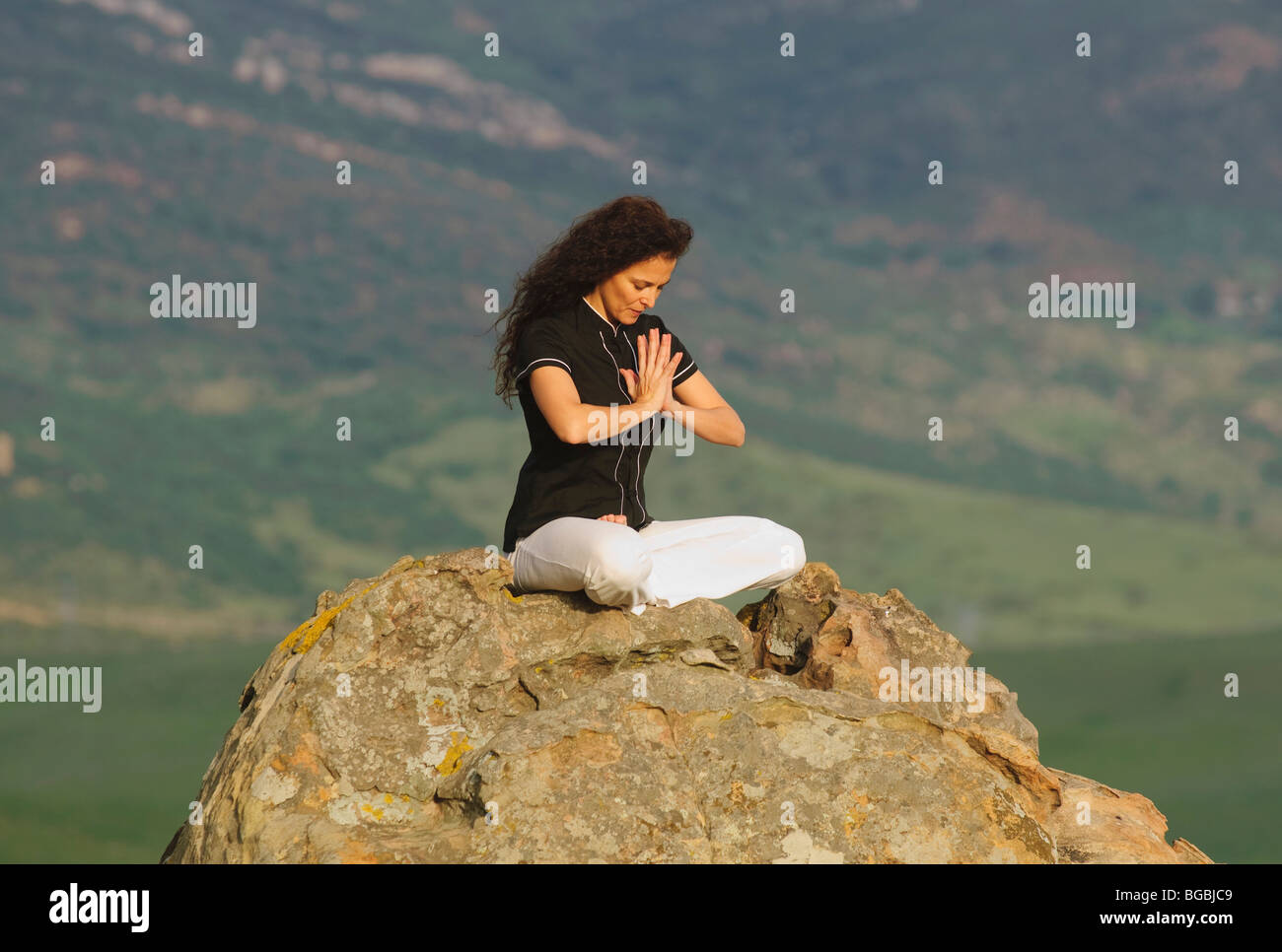 Woman posing on rocks mountain hi-res stock photography and images - Alamy