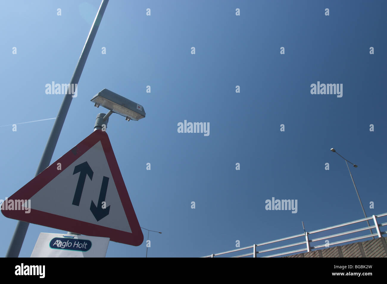Two way traffic straight ahead UK road sign Stock Photo