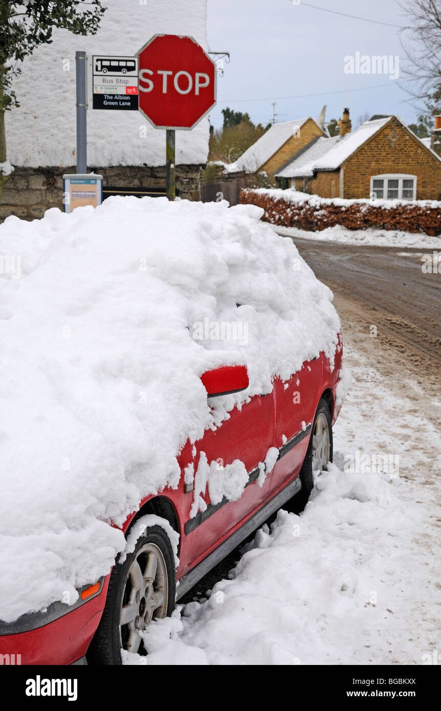 Cars in the snow at a bus stop. Boughton Monchelsea, Maidstone, Kent