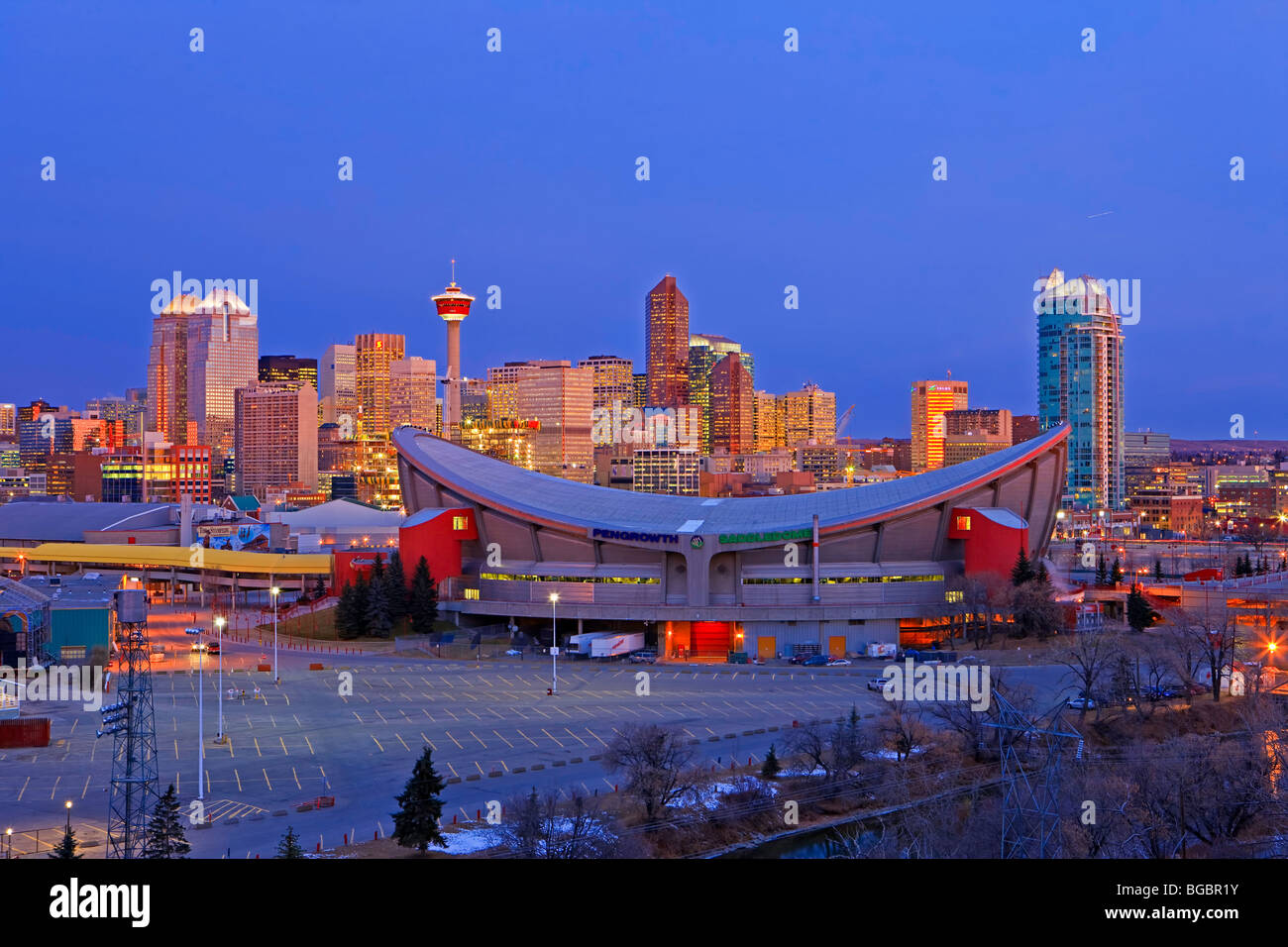 The Saddledome with highrise buildings and the Calgary Tower in the