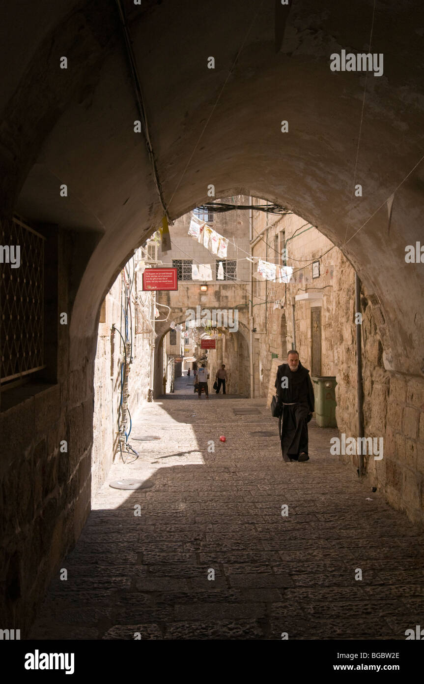 Franciscan monk walking in an ally in the Christian Quarter of the Old City of Jerusalem Stock Photo