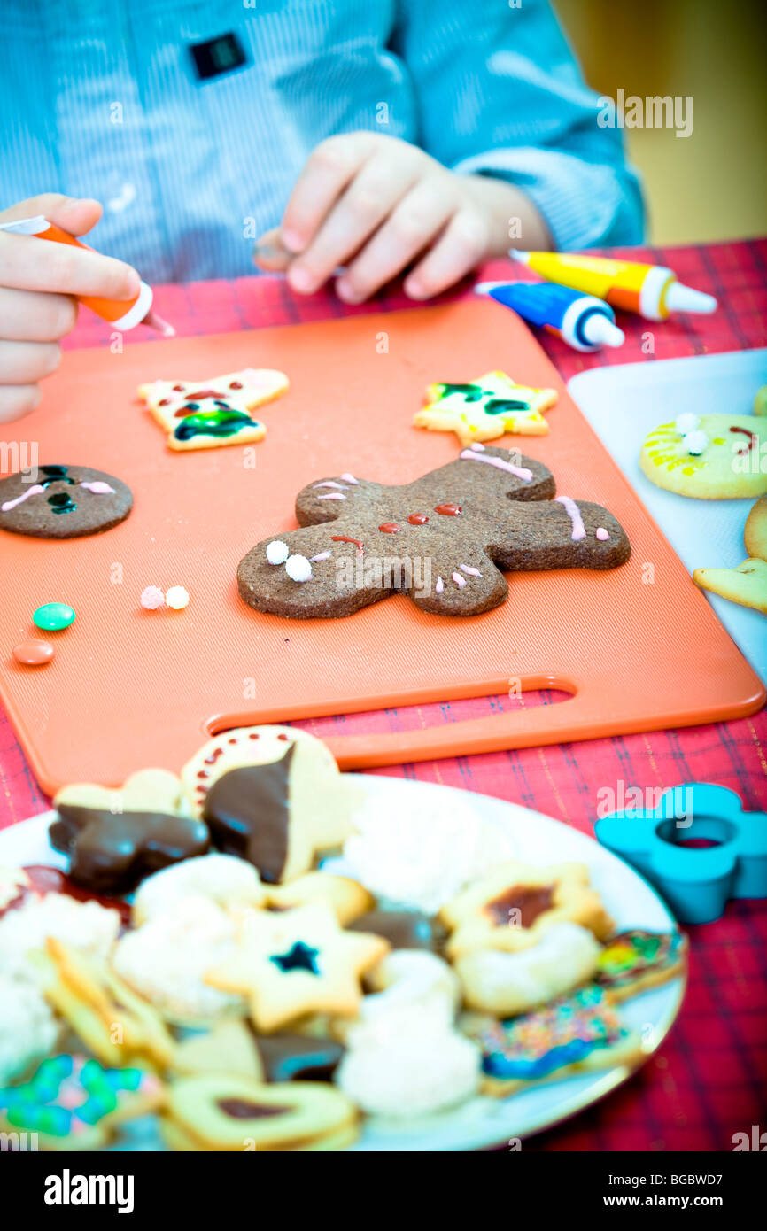 Christmas cookies, child decorating Christmas cookies Stock Photo - Alamy
