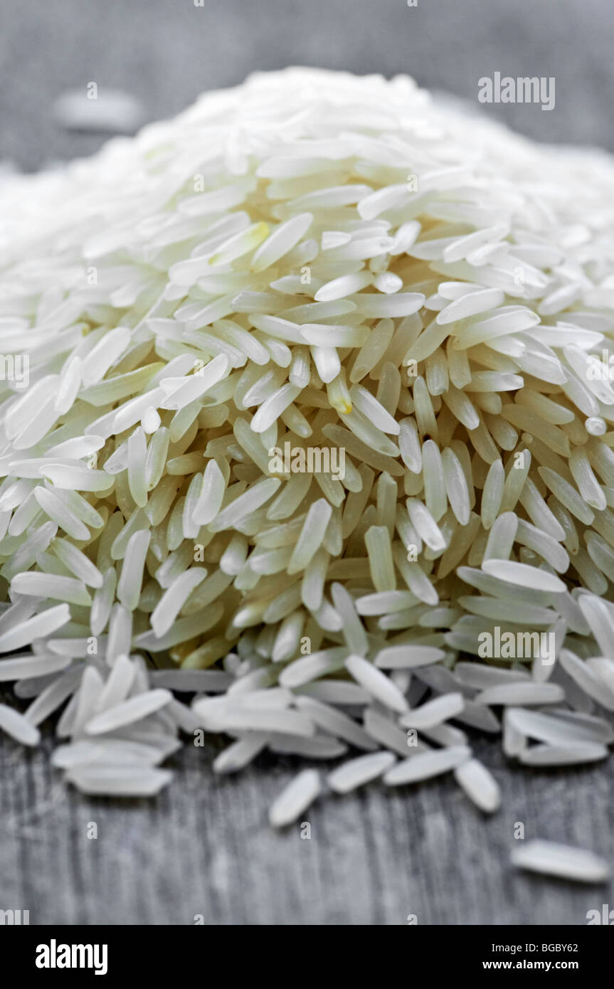 Pile of raw long grain white rice grains Stock Photo