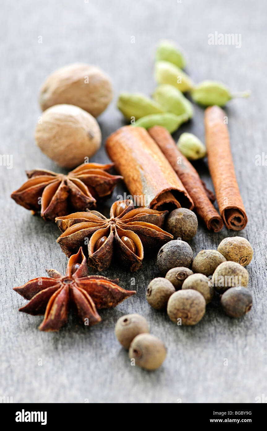 Assorted whole spices close up on wooden background Stock Photo