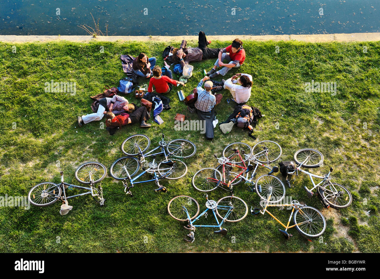 Friends taking a break on the bank of the river Garonne, Toulouse, France. Stock Photo