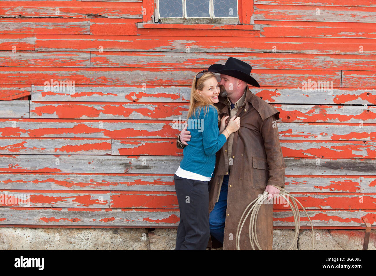 Cowboy kissing woman Stock Photo