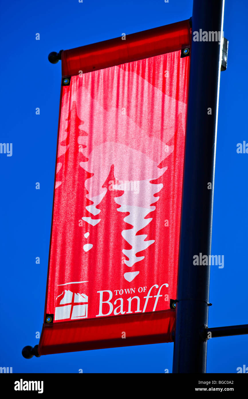Red sign along Banff Avenue backdropped by a blue sky, town of Banff, Banff National Park, Canadian Rocky Mountains, Alberta, Ca Stock Photo