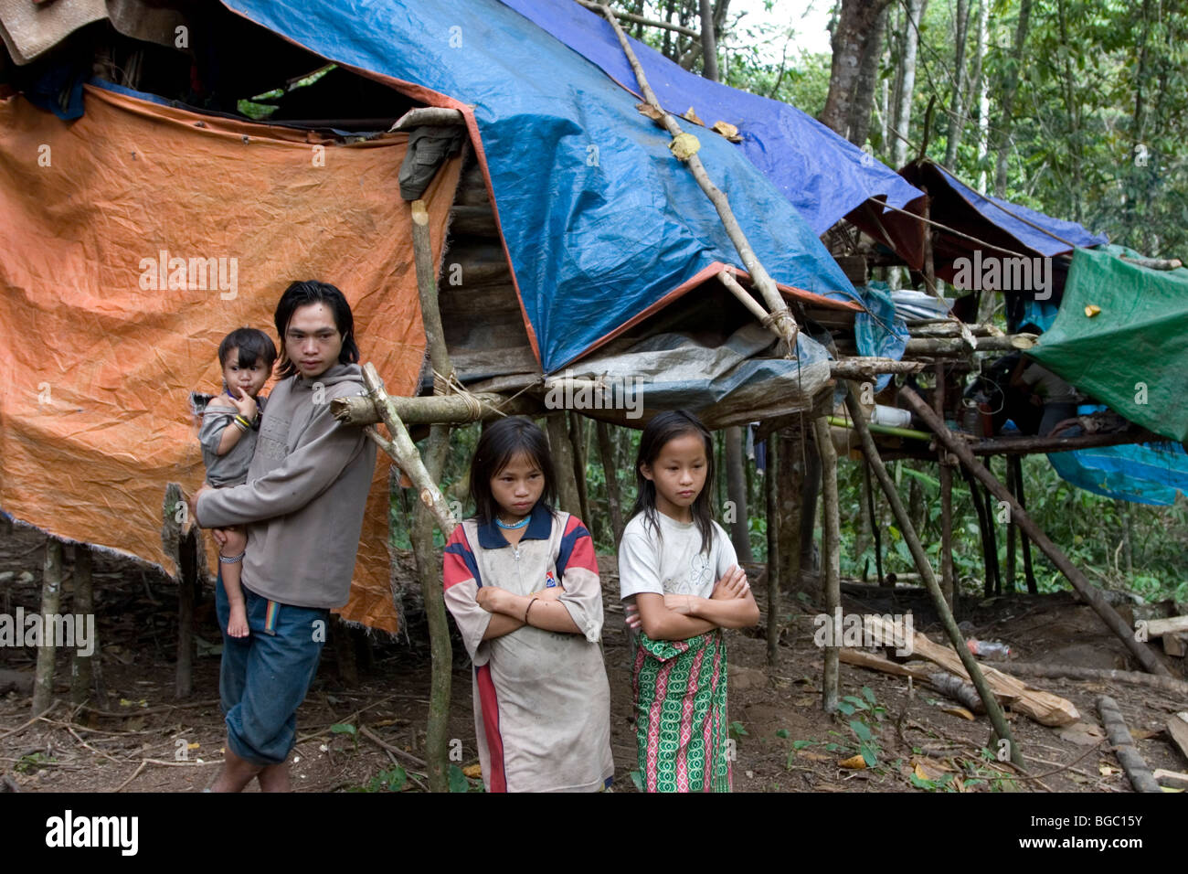 A Penan family outside their makeshift hut in Bario at the Kelabit Highlands in Sarawak in Borneo. Stock Photo