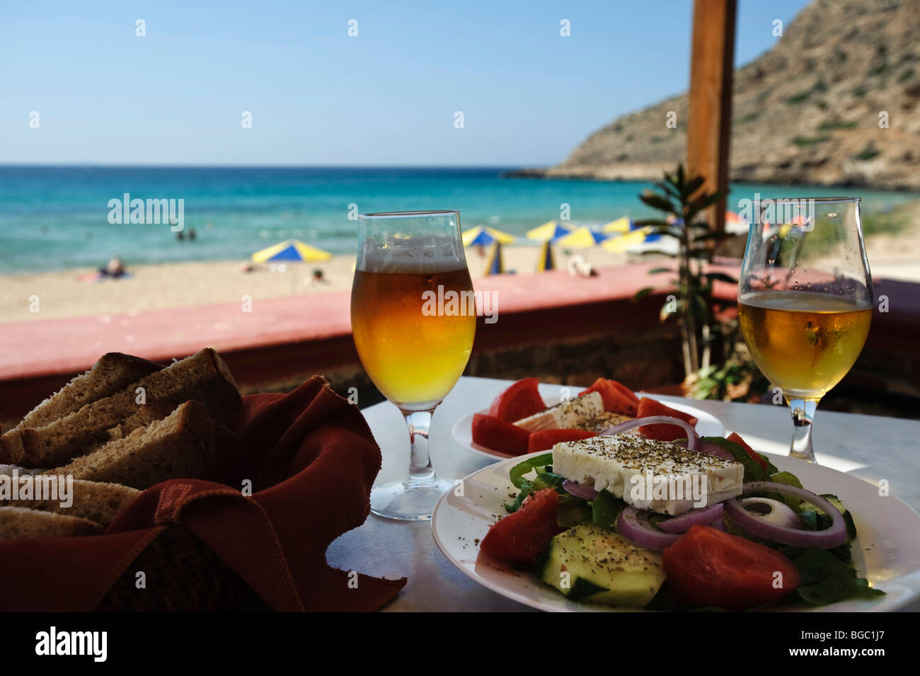 Beer glasses and Greek salad in a tavern, Arkassa, Karpathos, Aegean Islands, Aegean Sea, Greece, Europe Stock Photo