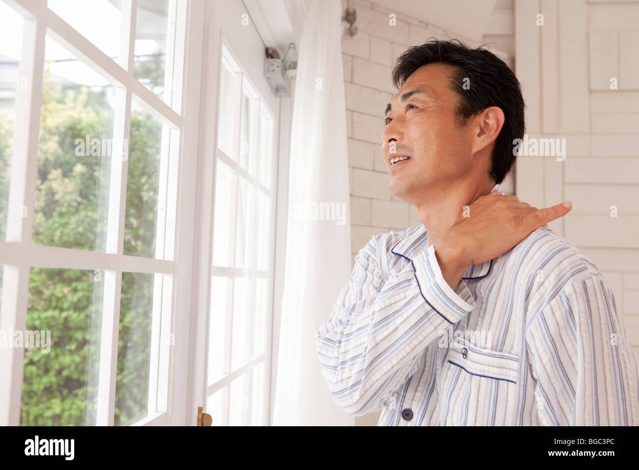 Mature man suffering from pain on shoulder Stock Photo - Alamy