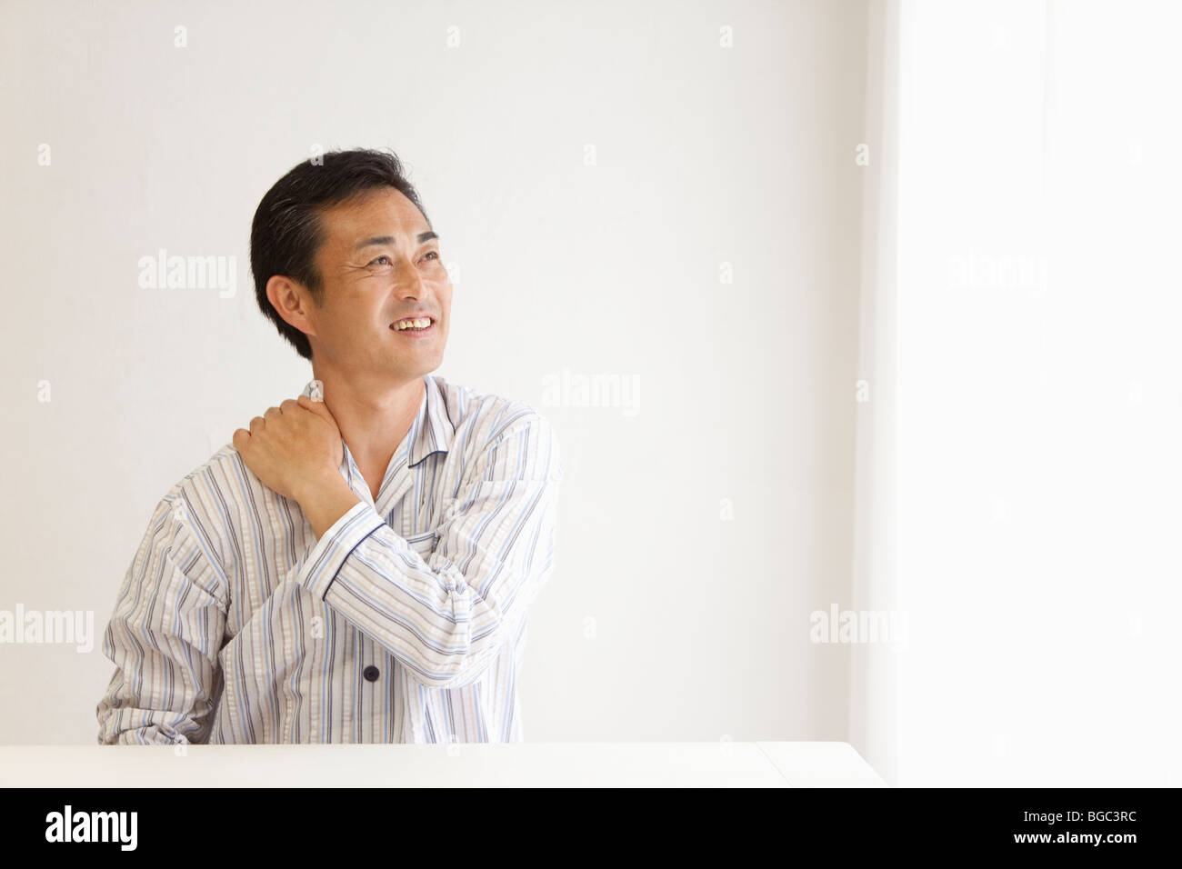 Mature man suffering from pain on shoulder Stock Photo - Alamy
