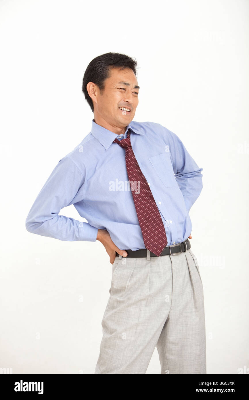 Mature man suffering from pain on back Stock Photo - Alamy