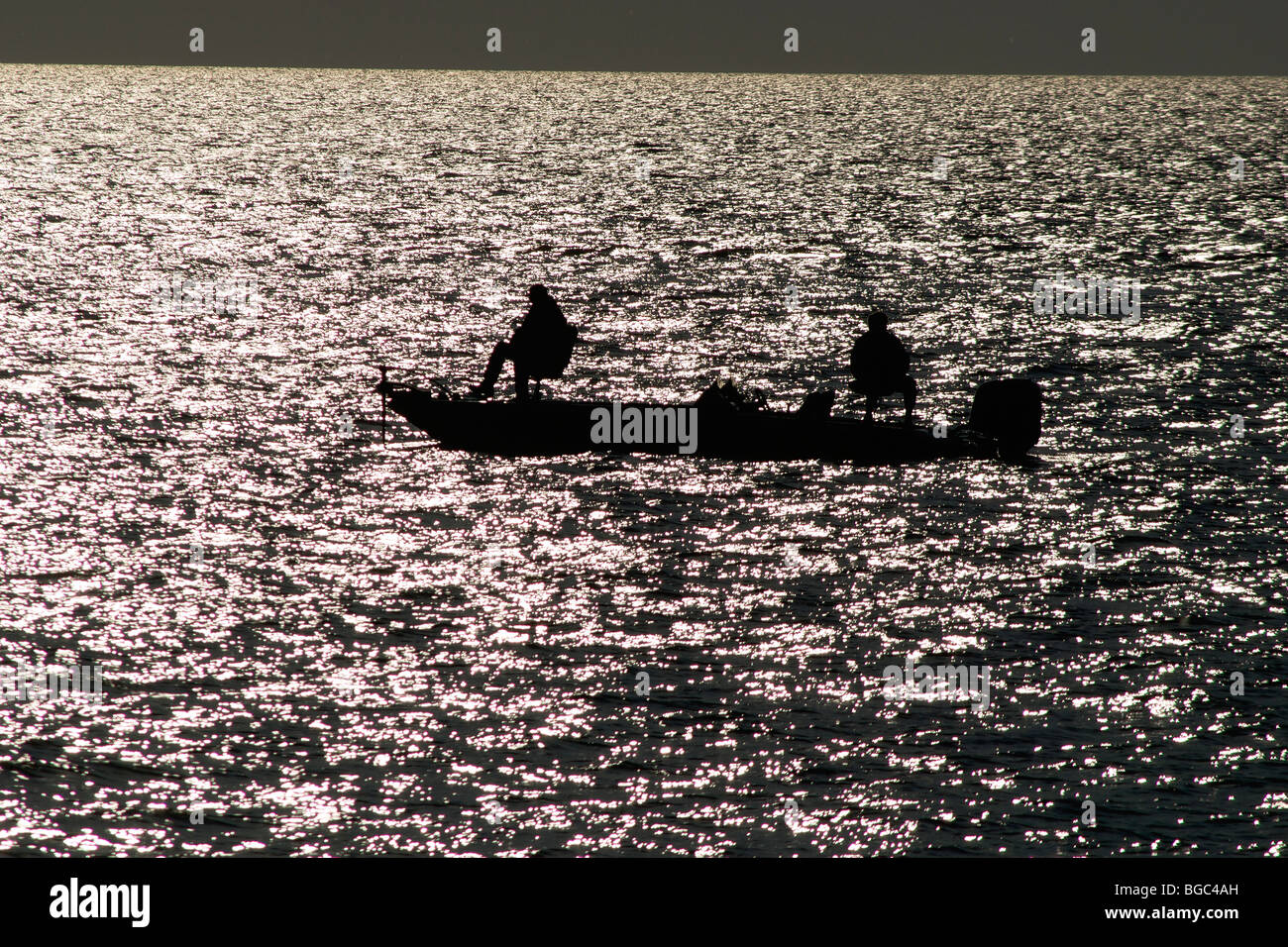 silhouette of fishermen taken from Lake Point Park in Marblehead, Ohio Stock Photo