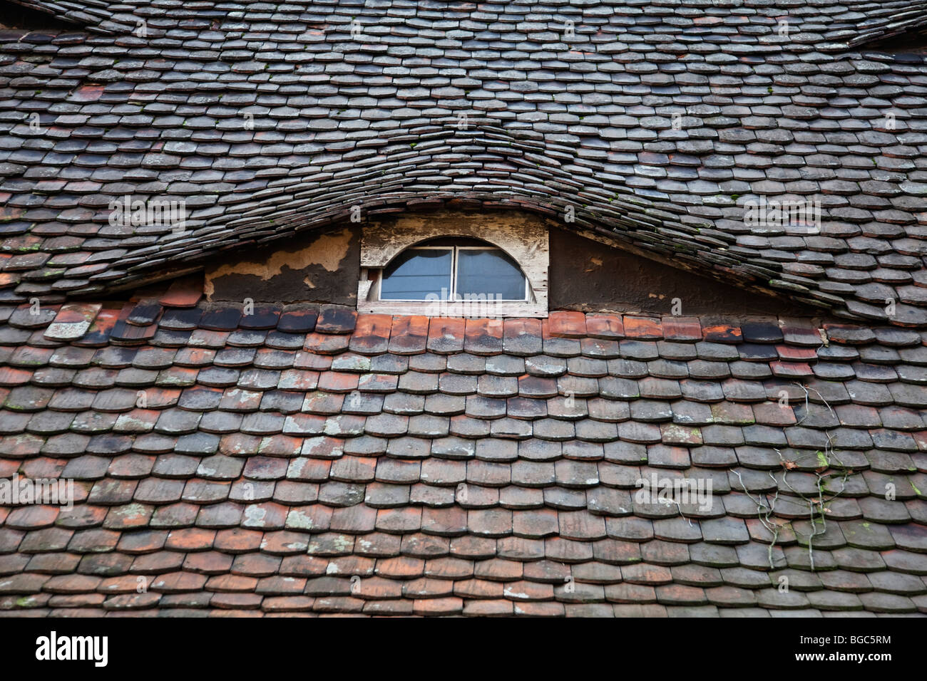 Old tile roof with window Stock Photo