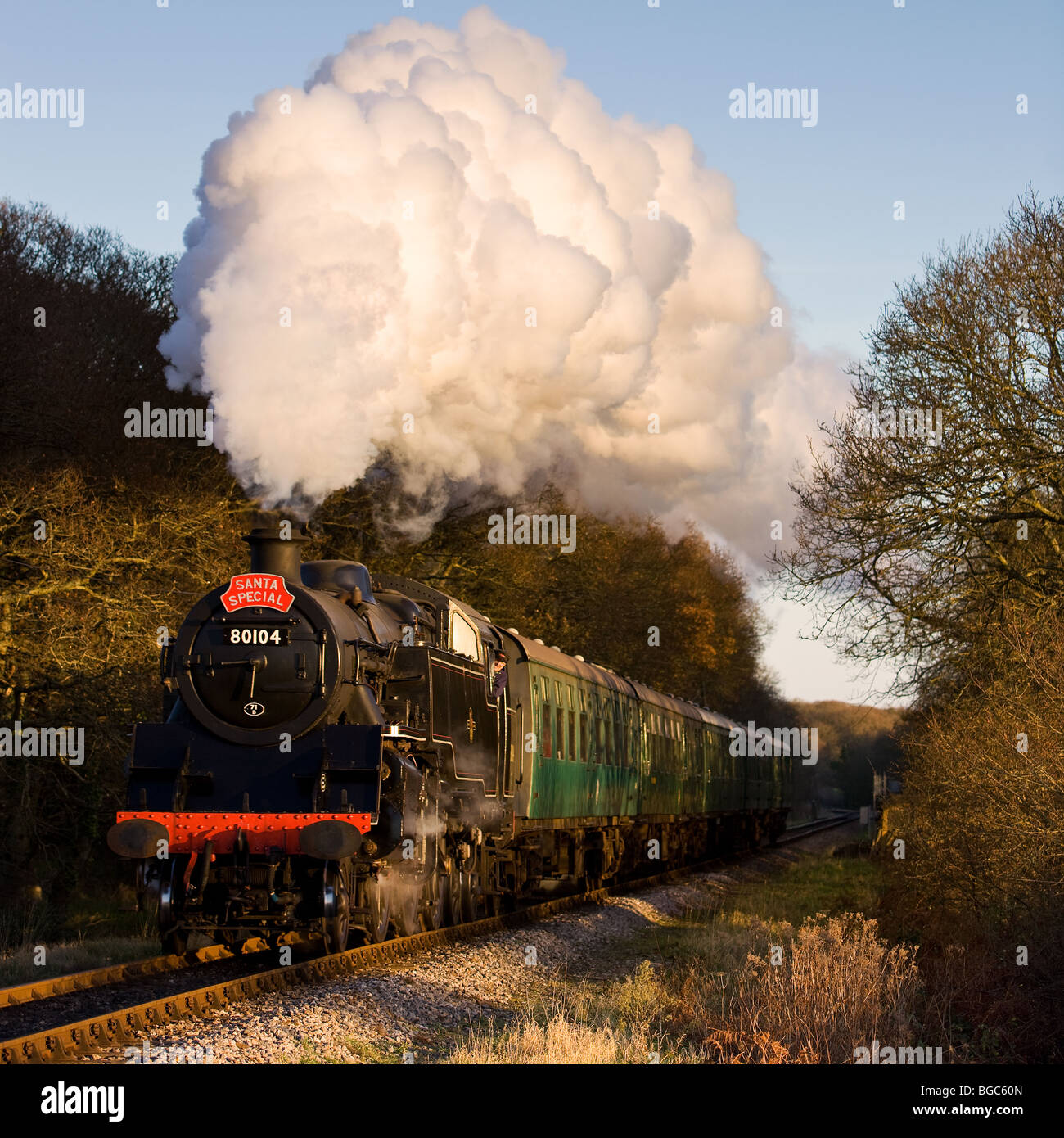 Ex British Railways Class 4 80104 approaches Harmans Cross on the Swanage Railway, Dorset with a 'Santa Special' service. Stock Photo
