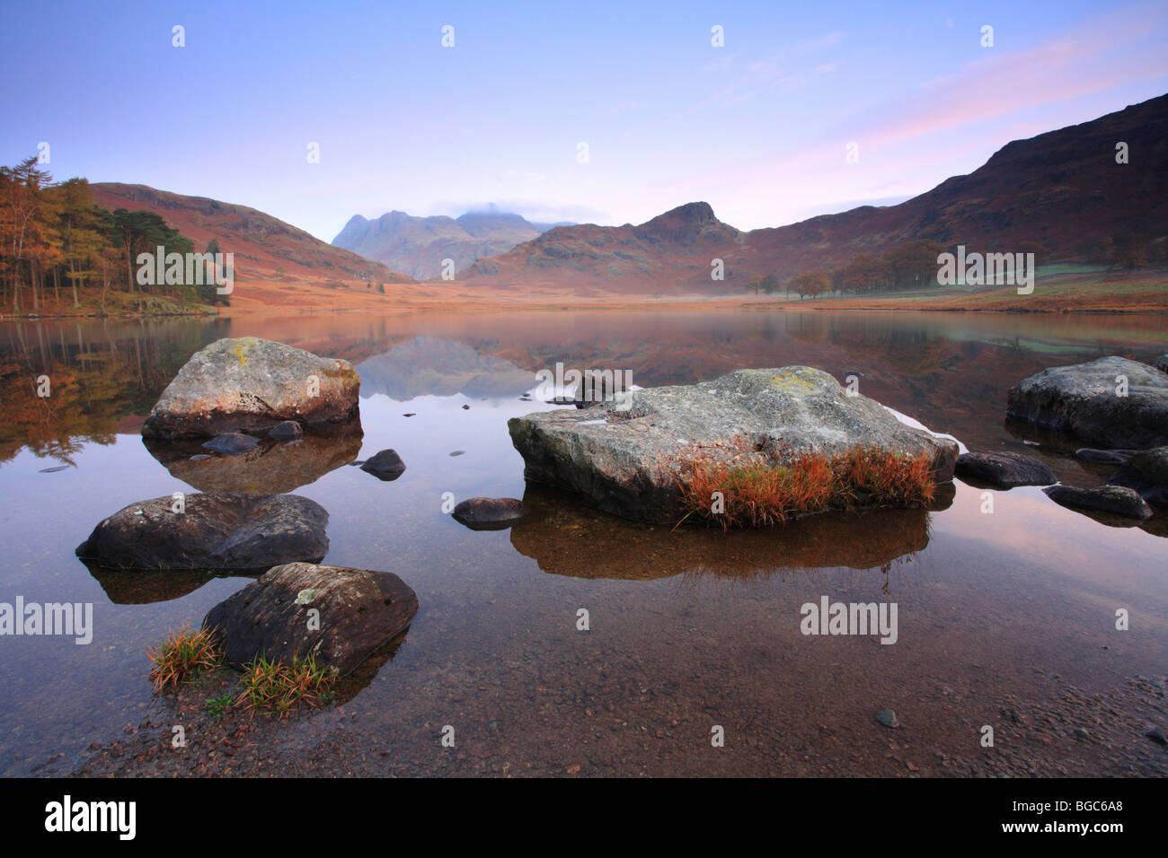 'Blea Tarn Little Langdale' rocks reflected at the waters edge, Lake District National Park, UK. Stock Photo