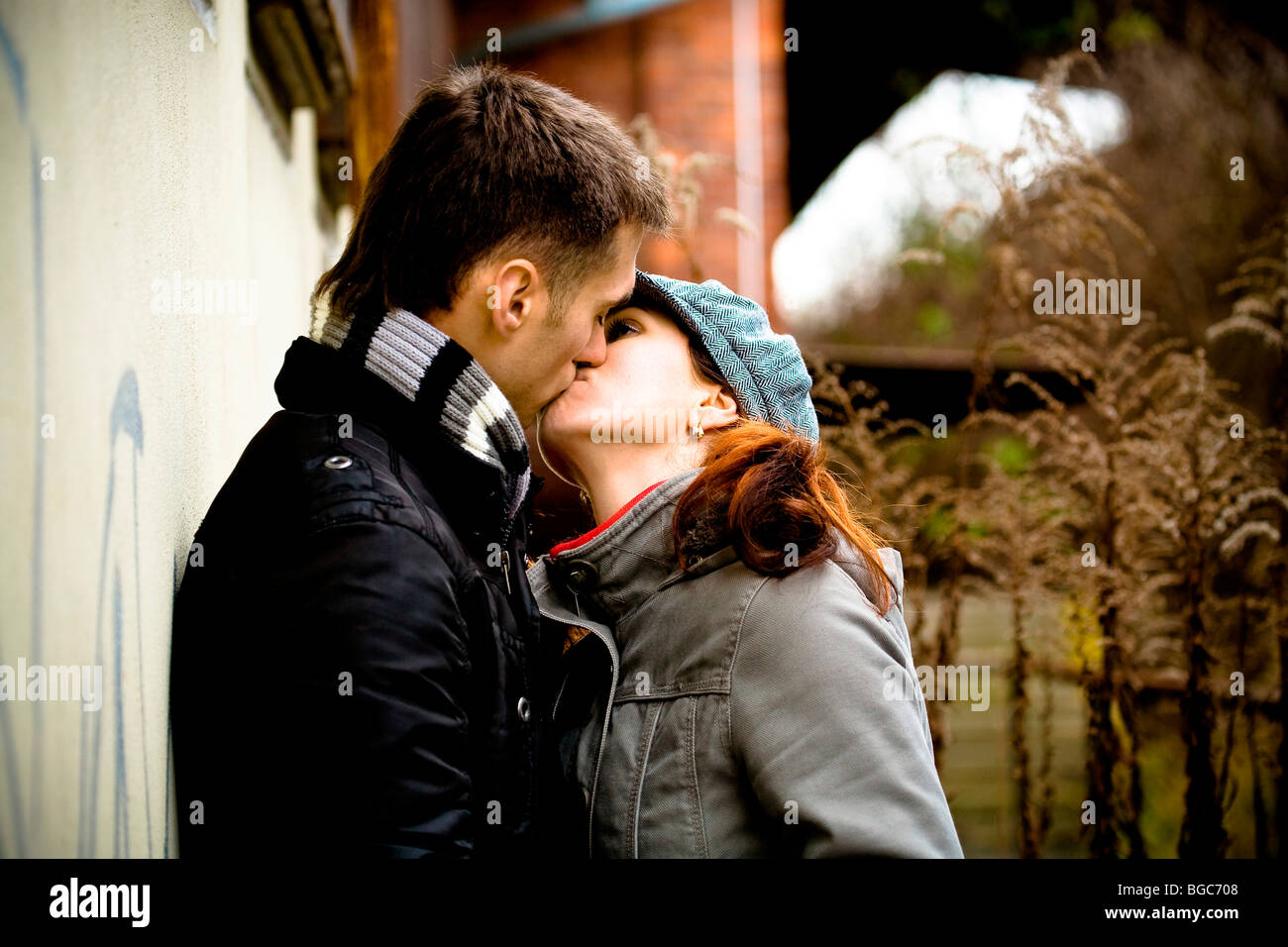 Couple caps coats kiss hi-res stock photography and images - Alamy