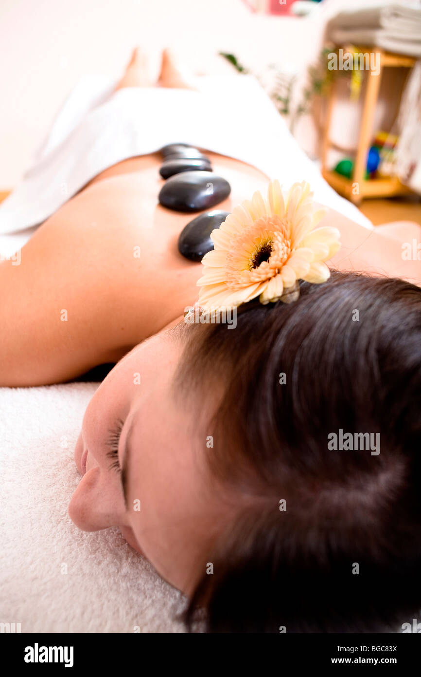 Patient in a physiotherapy practice getting a Hot Stone Massage Stock Photo