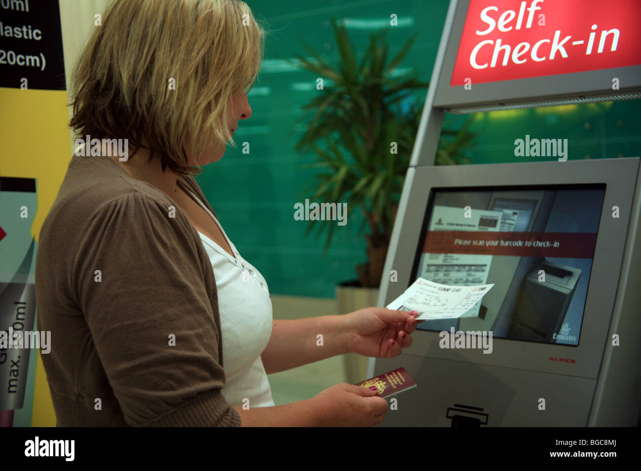 Self-check in and using a passport scanner at Dubai Airport Stock Photo ...