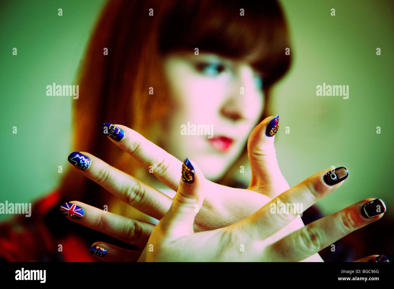 Teenage girl with bespoke painted fingernail art Stock Photo