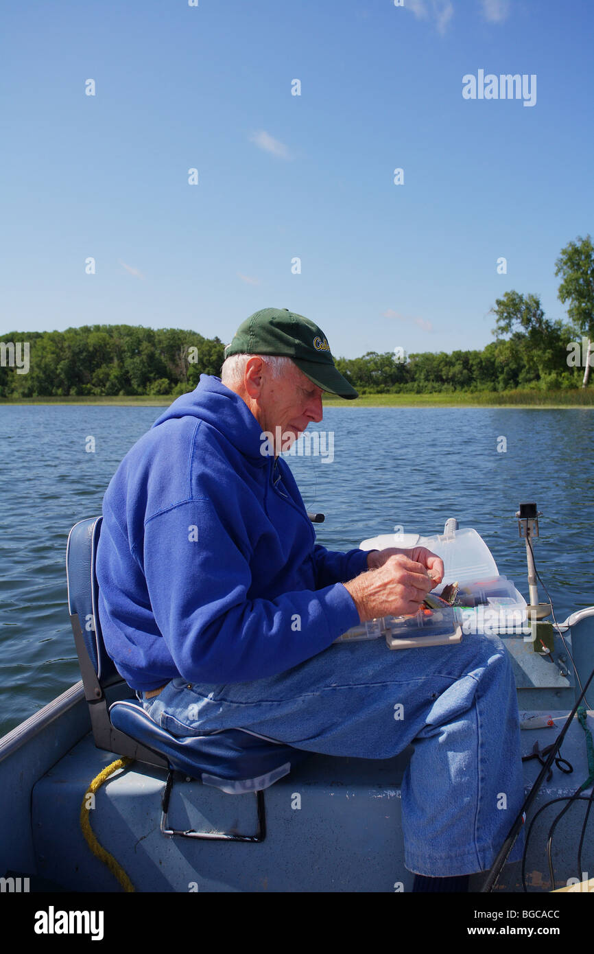 seasoned elderly senior fishing guide fishing in alumnacraft boat Stock Photo