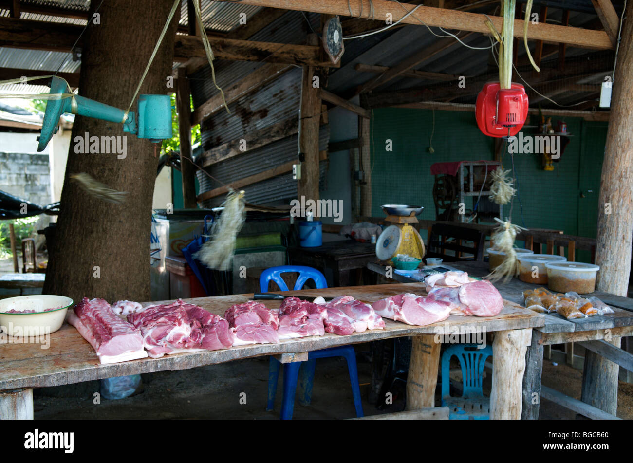 butcher meat for sale in a market in thailand with converted fans to