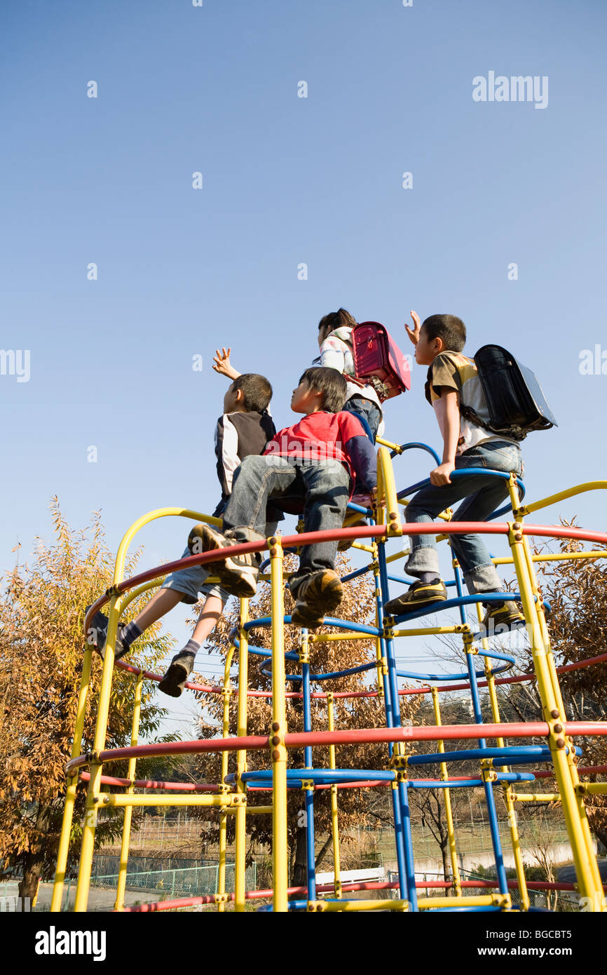 Four children playing on jungle gym Stock Photo Alamy
