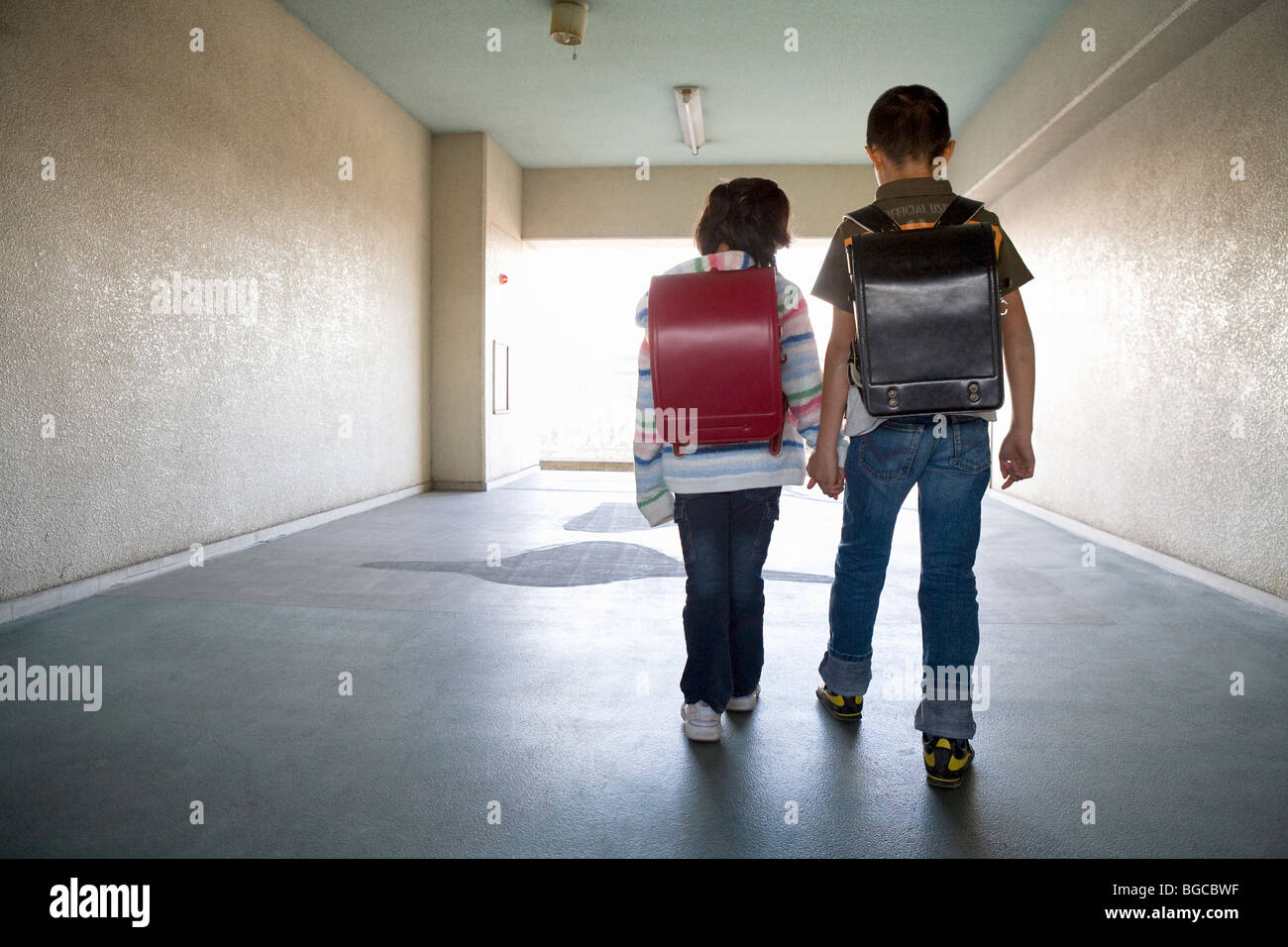 Boy and girl walking hallway Stock Photo