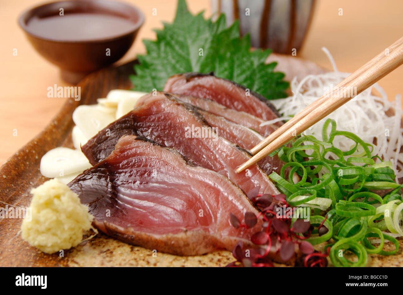 Seared Bonito sashimi and sake Stock Photo