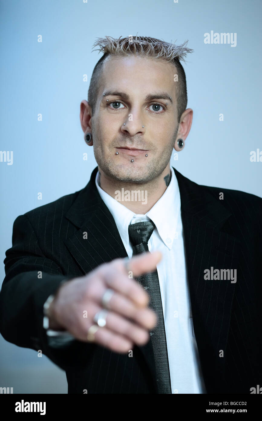 Pensive tattooed businessman in grey suit isolated on grey  Stock Photo   Dissolve