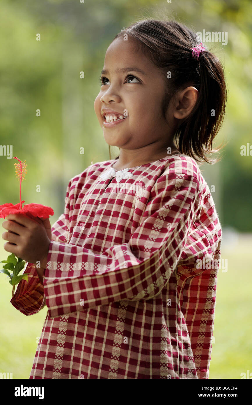 Little girl giving a flower Stock Photo Alamy
