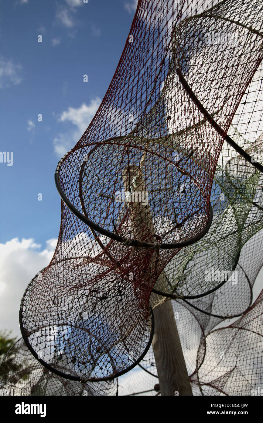 Drying fish trap nets on drying ground against a blue sky with