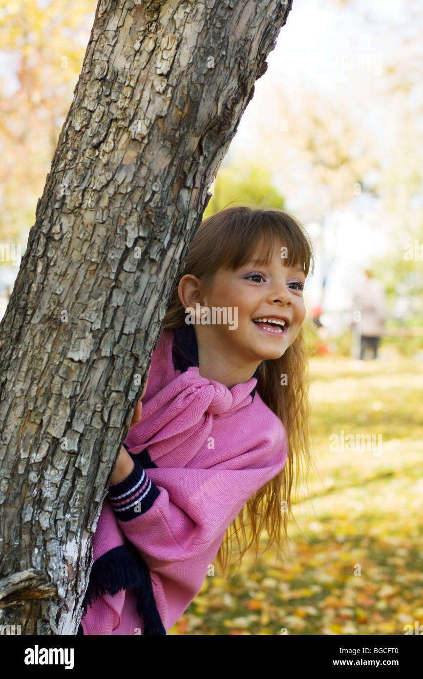 Happy little girl playing in the park Stock Photo - Alamy