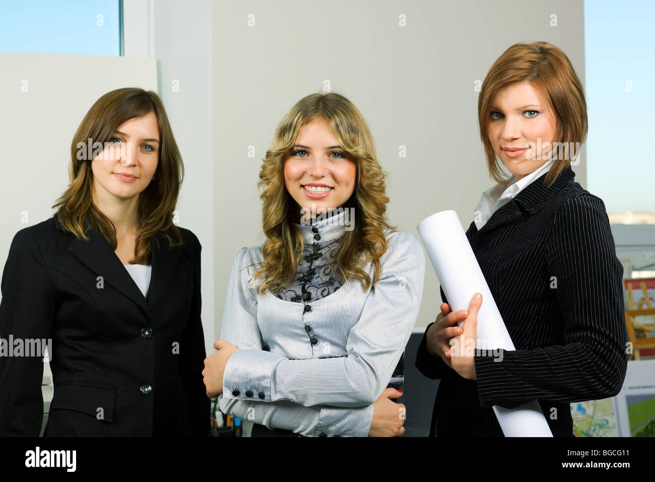 Three young businesswoman in an office Stock Photo - Alamy