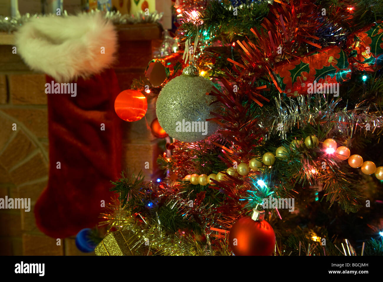 decorated christmas tree on christmas eve night in a living room in the uk Stock Photo