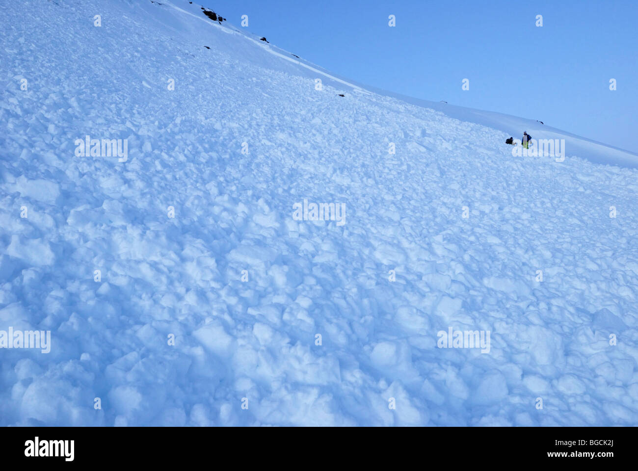 Two skiers caught in an avalanche, self extricating from partial burial, Tamokdalen, Norway Stock Photo