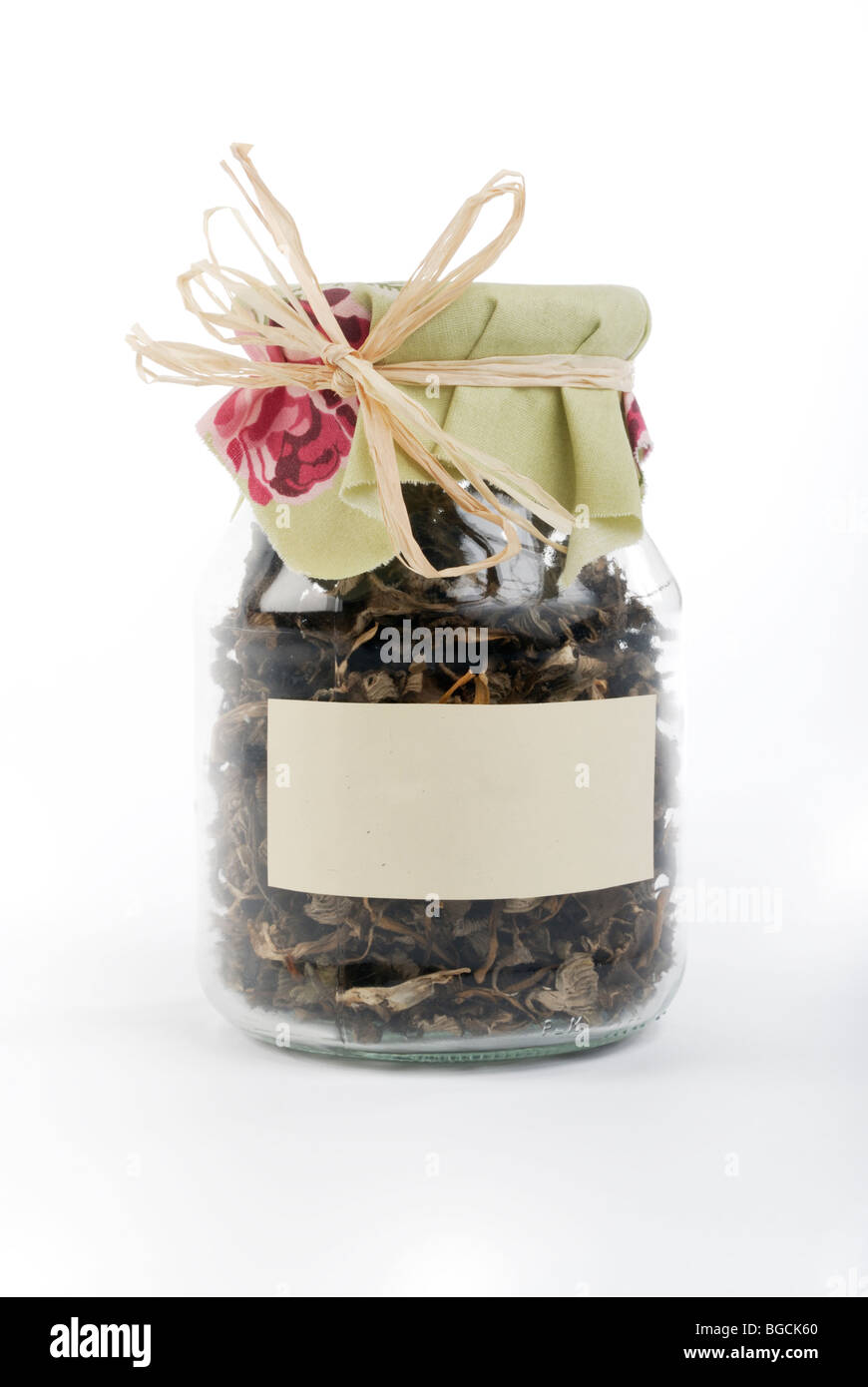 Cantharellus tubaeformis edible mushrooms in glass container with empty label Stock Photo